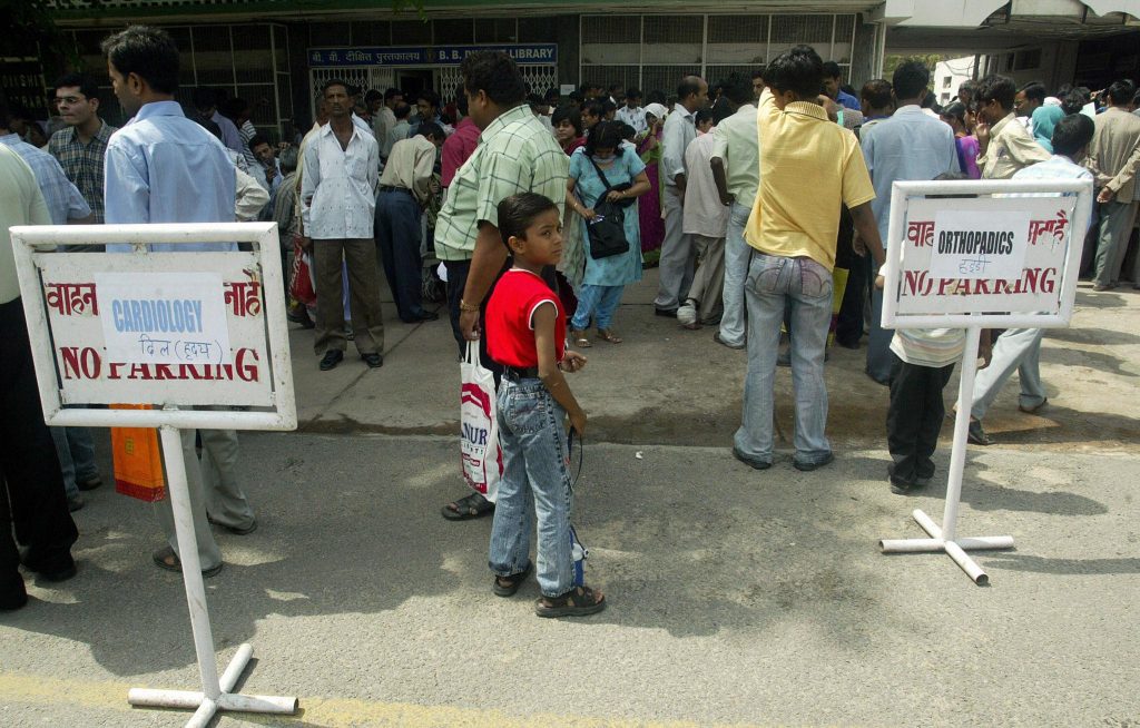People queuing outside a public hospital in India, waiting for medical services