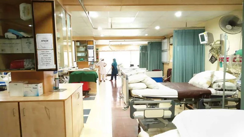 Public hospital treatment area with empty beds and basic furnishings in an Indian government hospital
